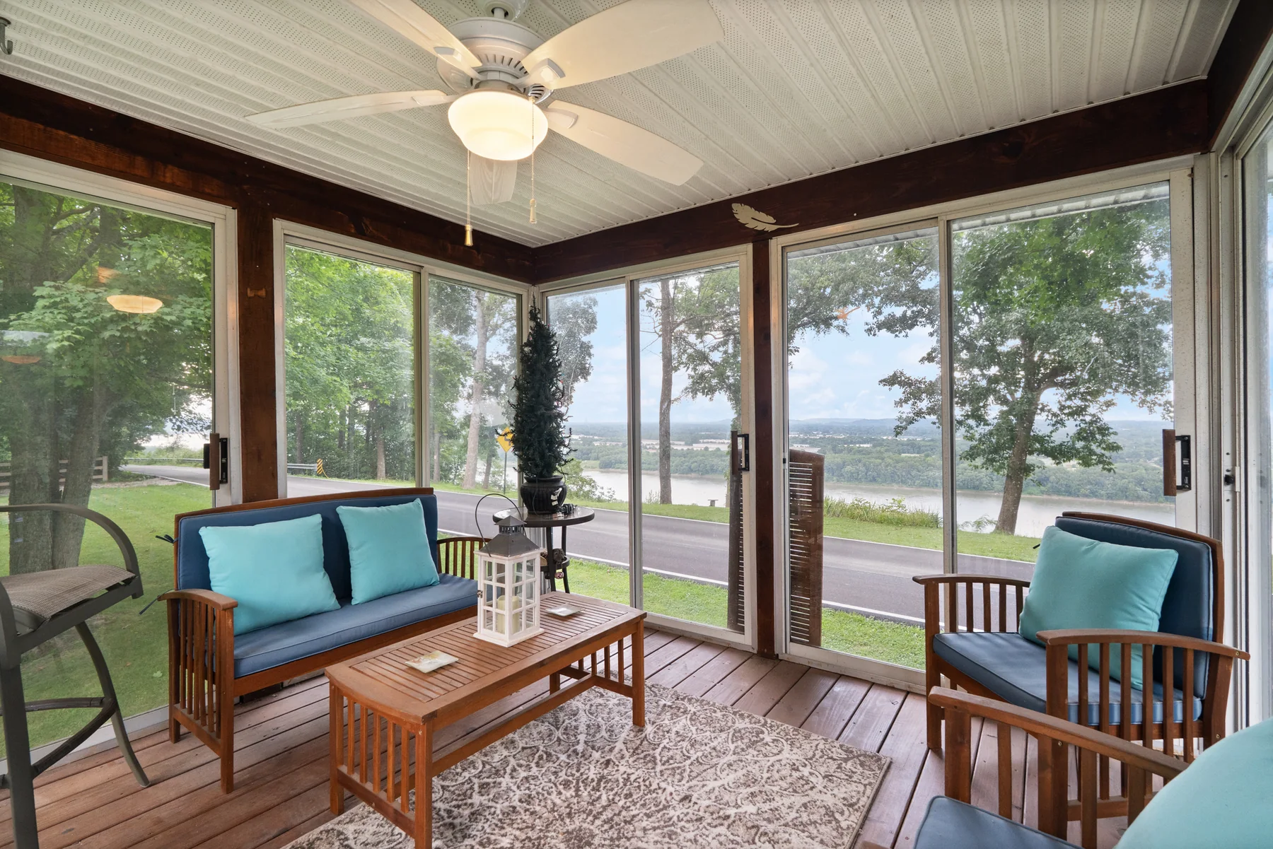 Screened gazebo arranged as a comfortable river-view sitting room
