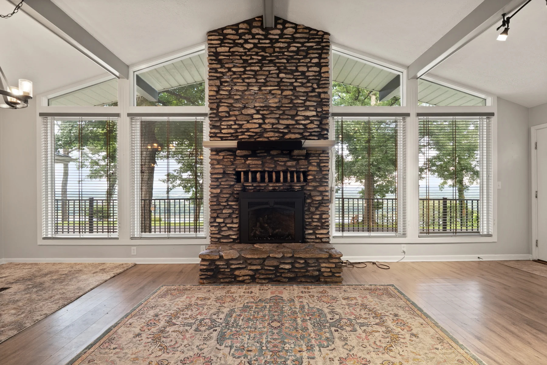 Vaulted great room with floor-to-ceiling stone fireplace