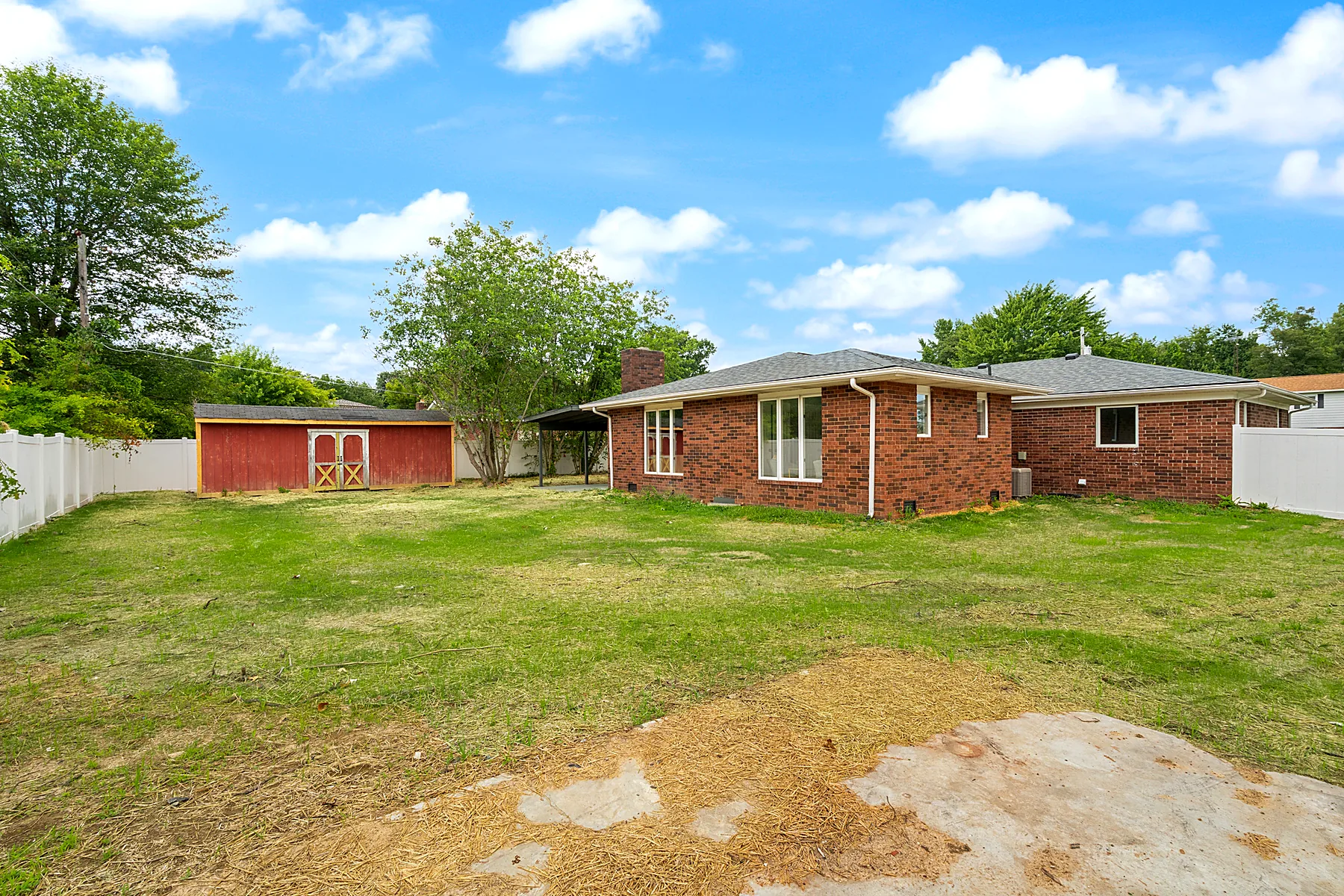 Fully fenced backyard with storage shed at 1219 W Carla Ln