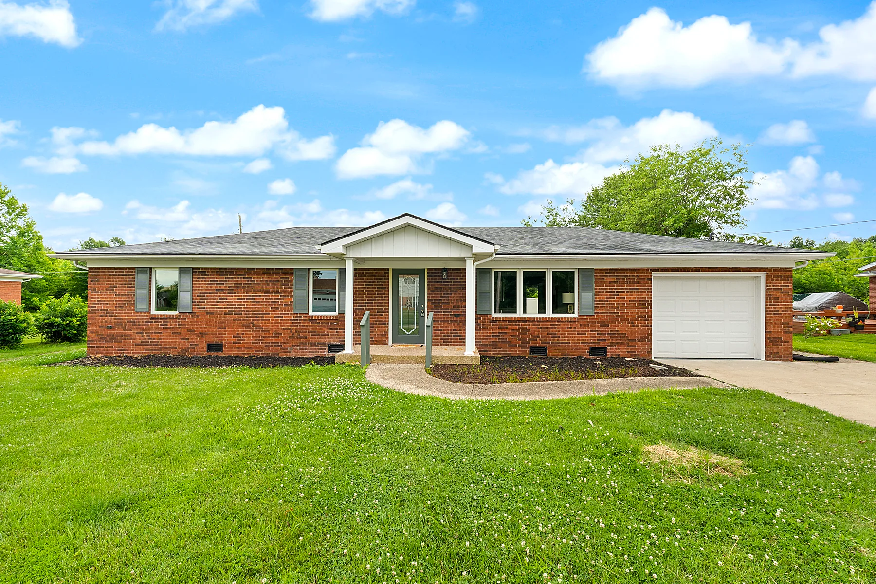 Front exterior of 1219 W Carla Ln, a single-level brick ranch in Scottsburg, Indiana