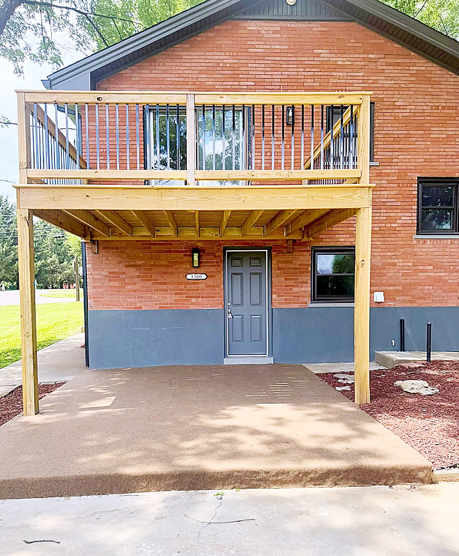 Large wooded rear deck overlooking the backyard and trees