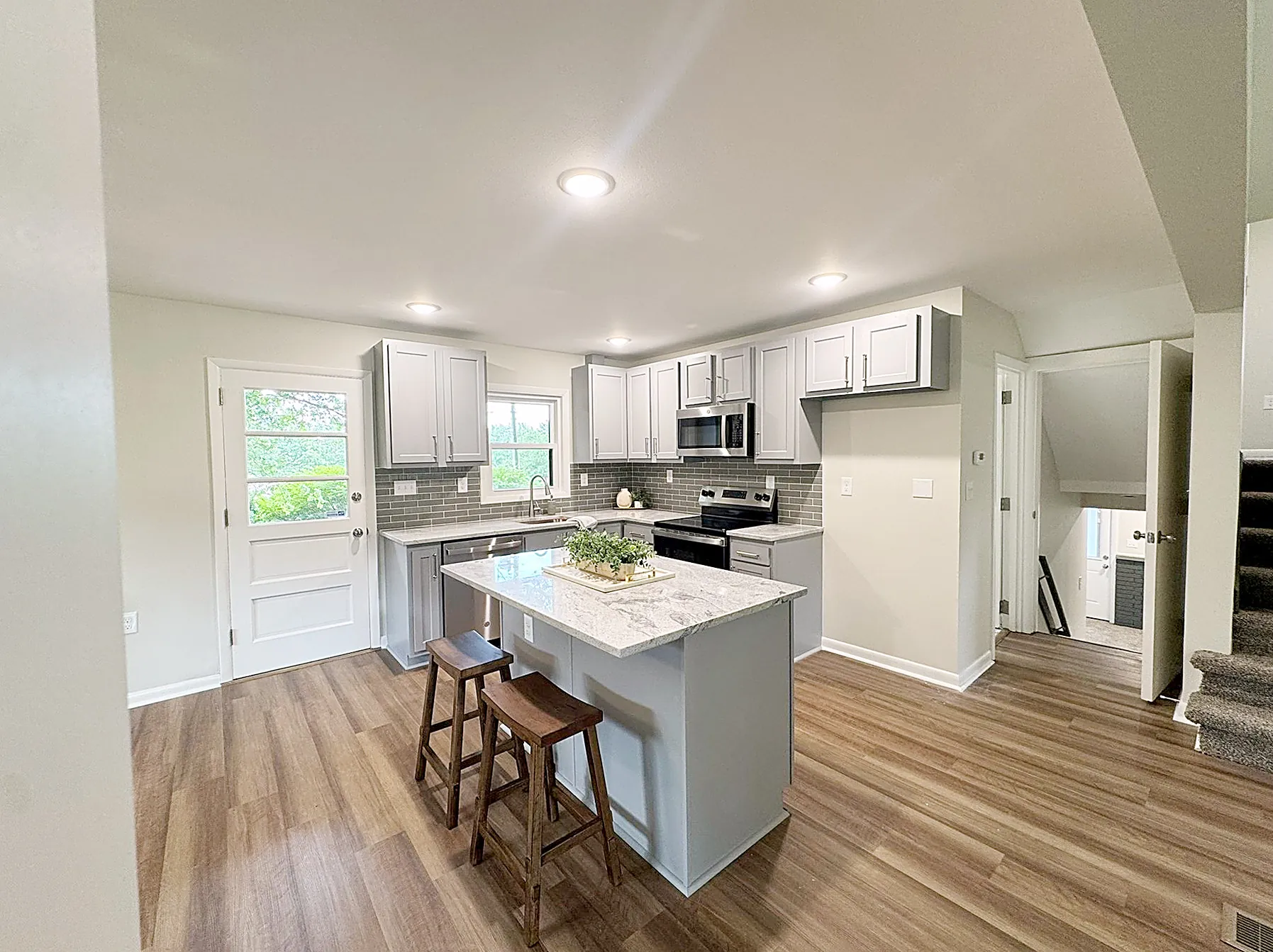 Kitchen with a large granite center island and stainless appliances