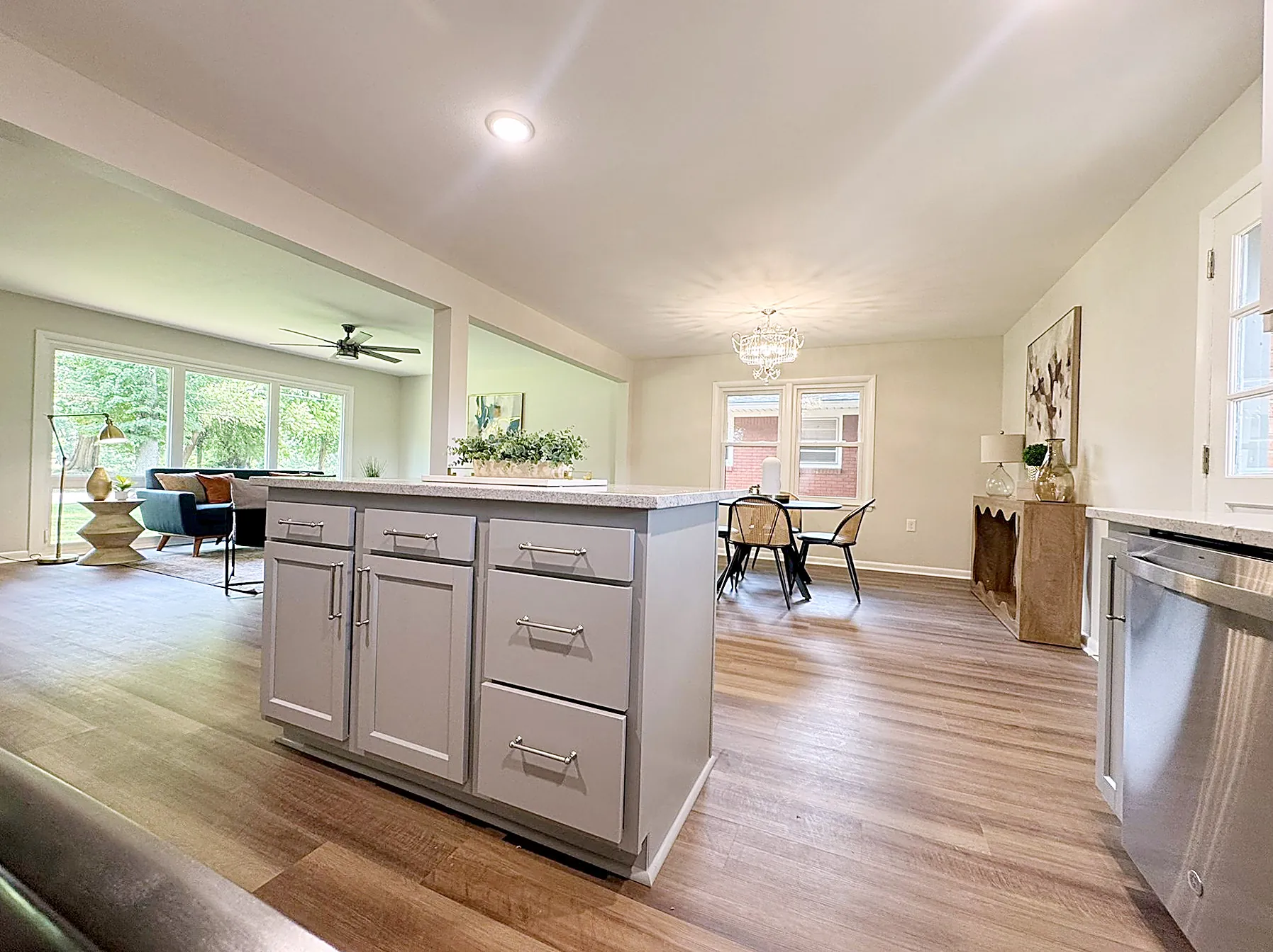Open living room flowing into the kitchen, with natural light across the connected main level