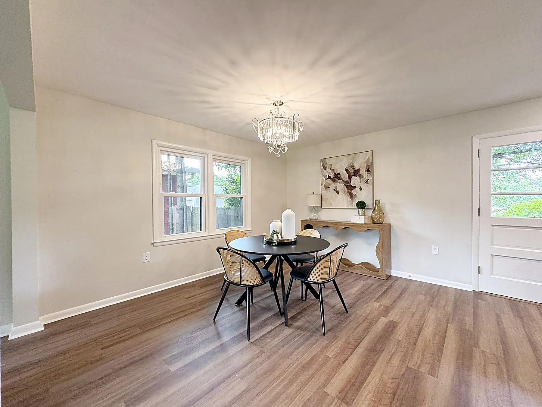 Dining area beneath a chandelier