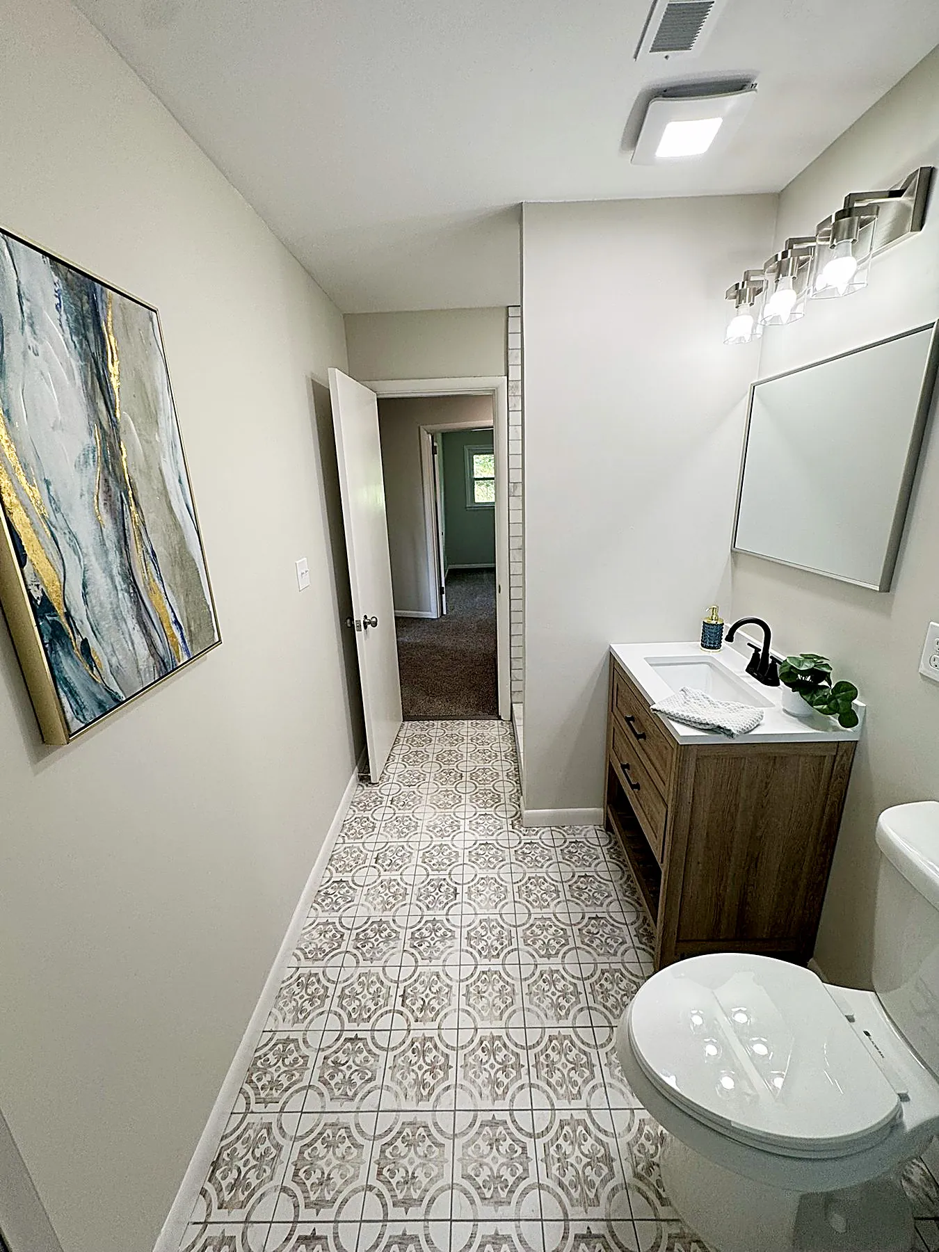 Bathroom with a wood vanity and updated fixtures