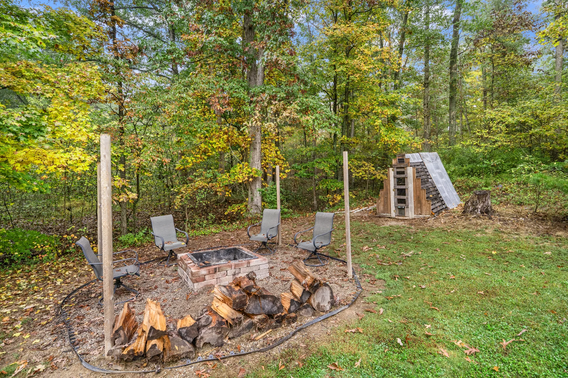 Wooded backyard and fire pit at 2206 Old State Road