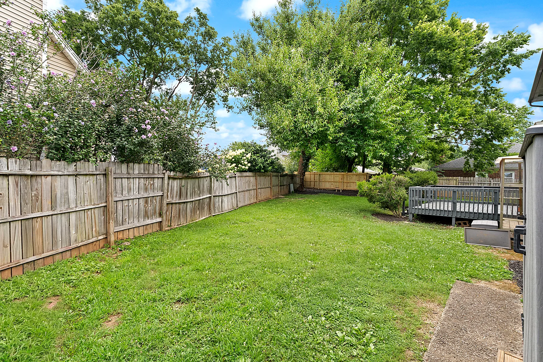 Fenced backyard with a deck at 2601 Stony Brook Drive