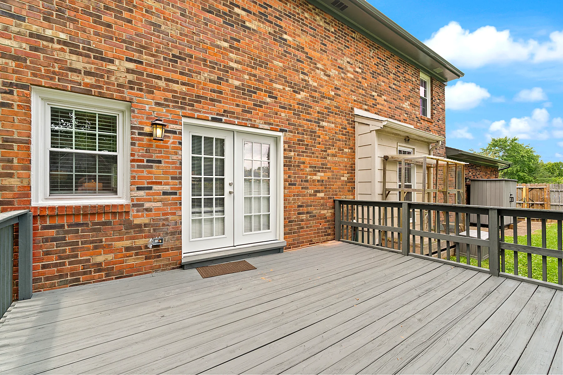 Deck overlooking the fenced backyard