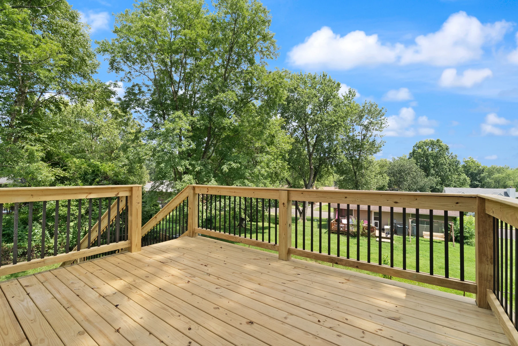 Raised rear deck overlooking the fenced backyard