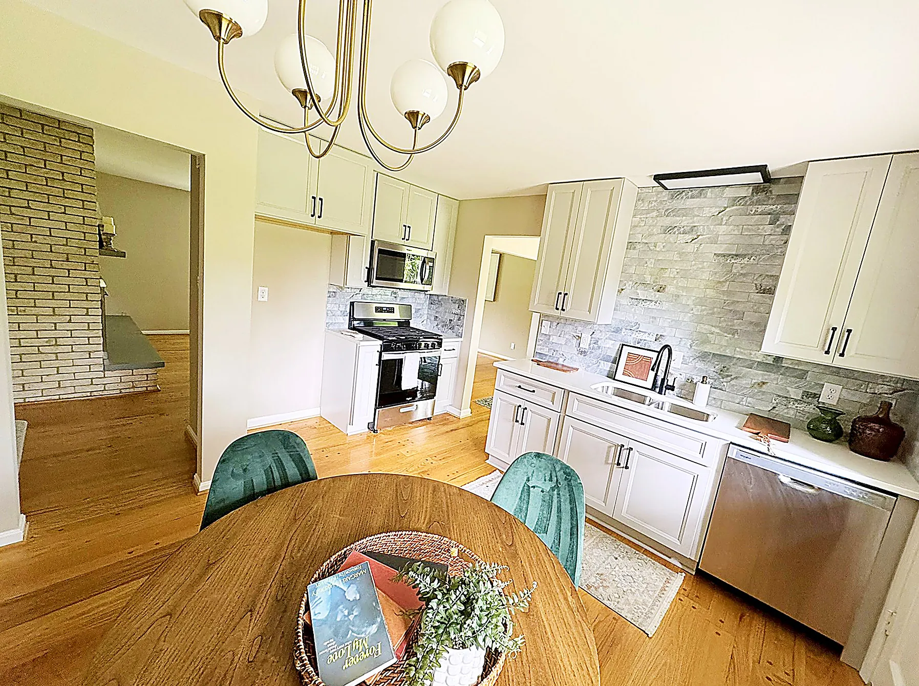 Updated kitchen with white shaker cabinets and stainless steel appliances