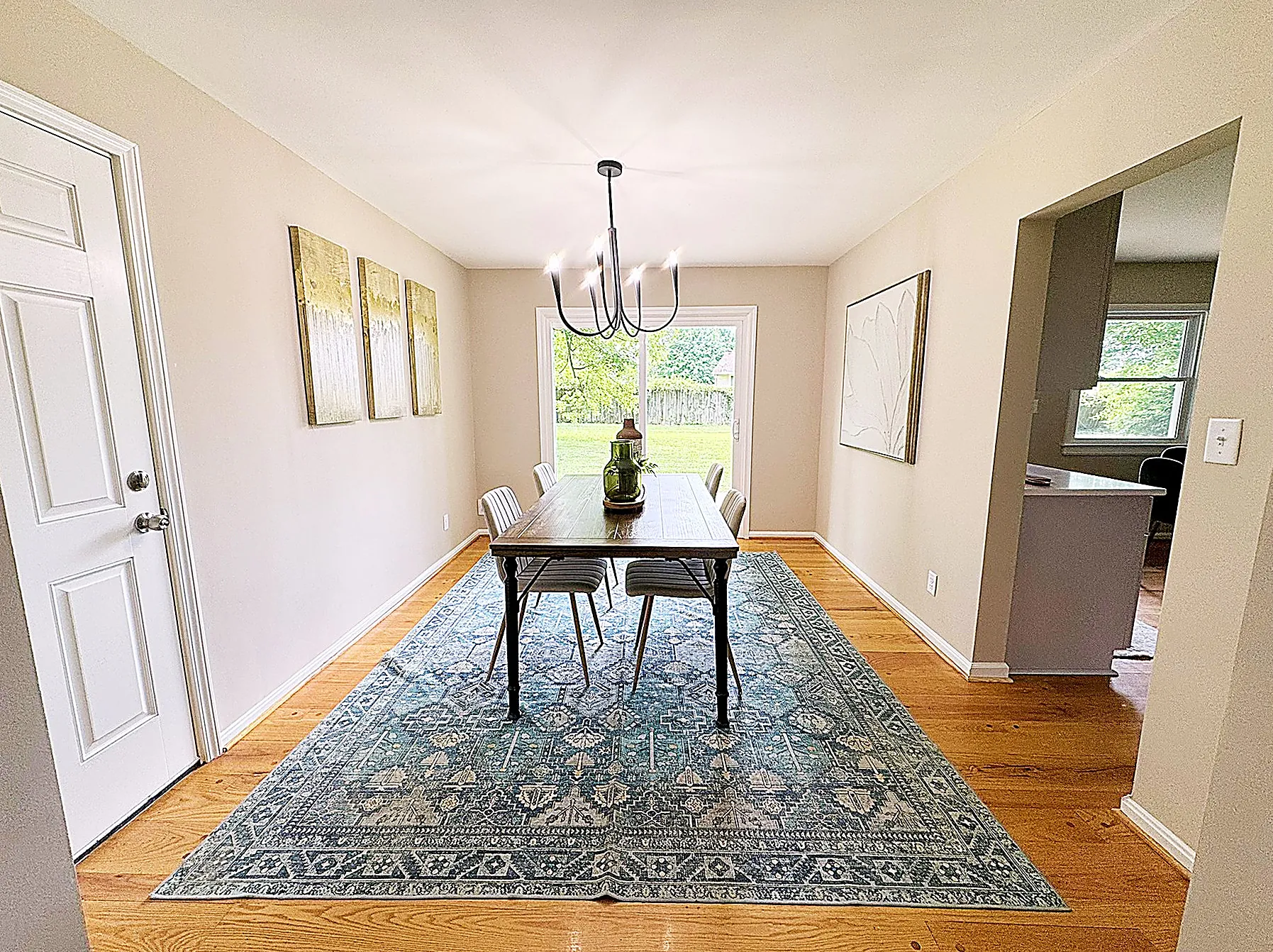 Formal dining room beneath a statement chandelier