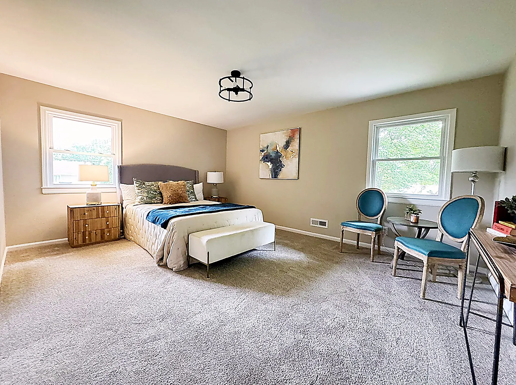Large primary suite with a staged bed and sitting area