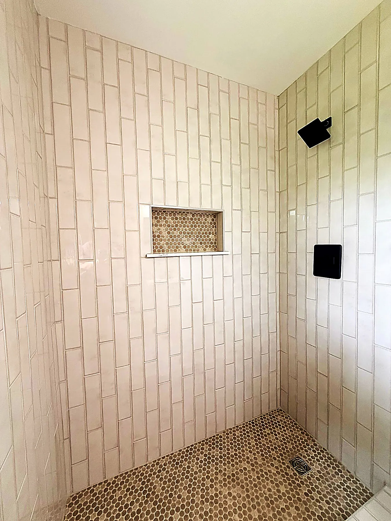 Fully tiled walk-in shower in the primary suite