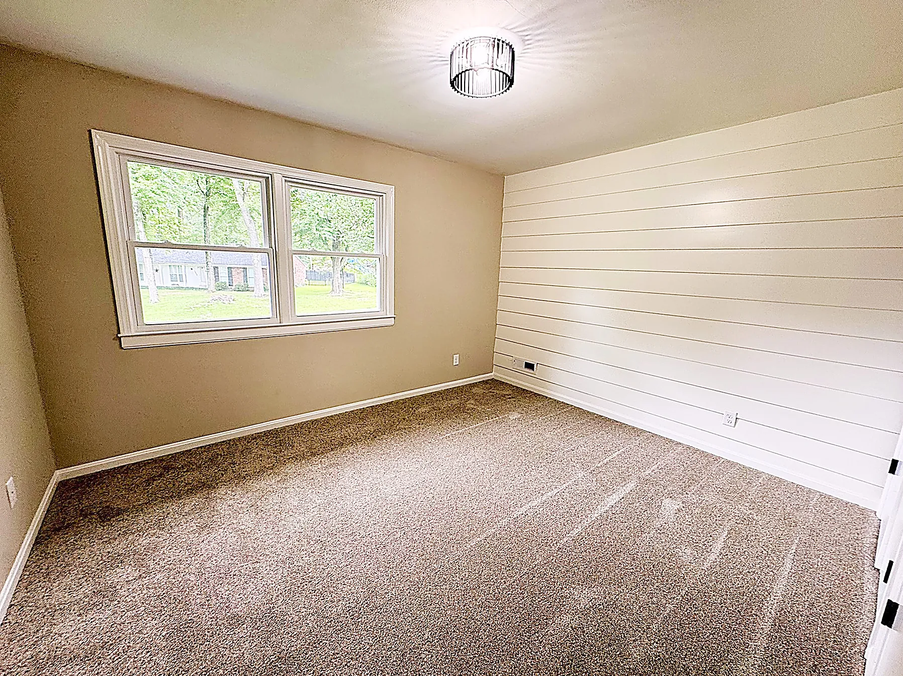 Bedroom with a shiplap accent wall