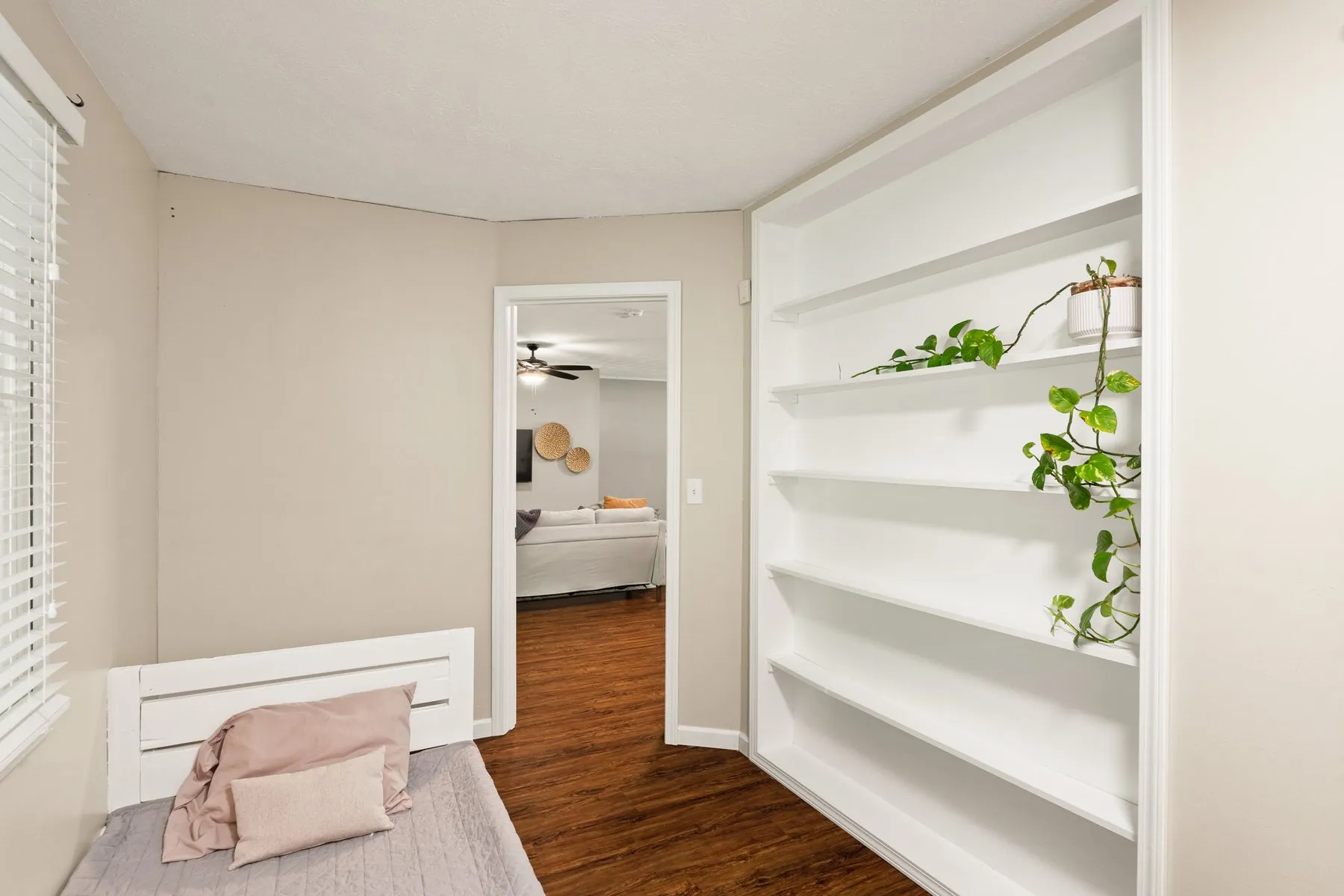 Third bedroom with full built-in shelving