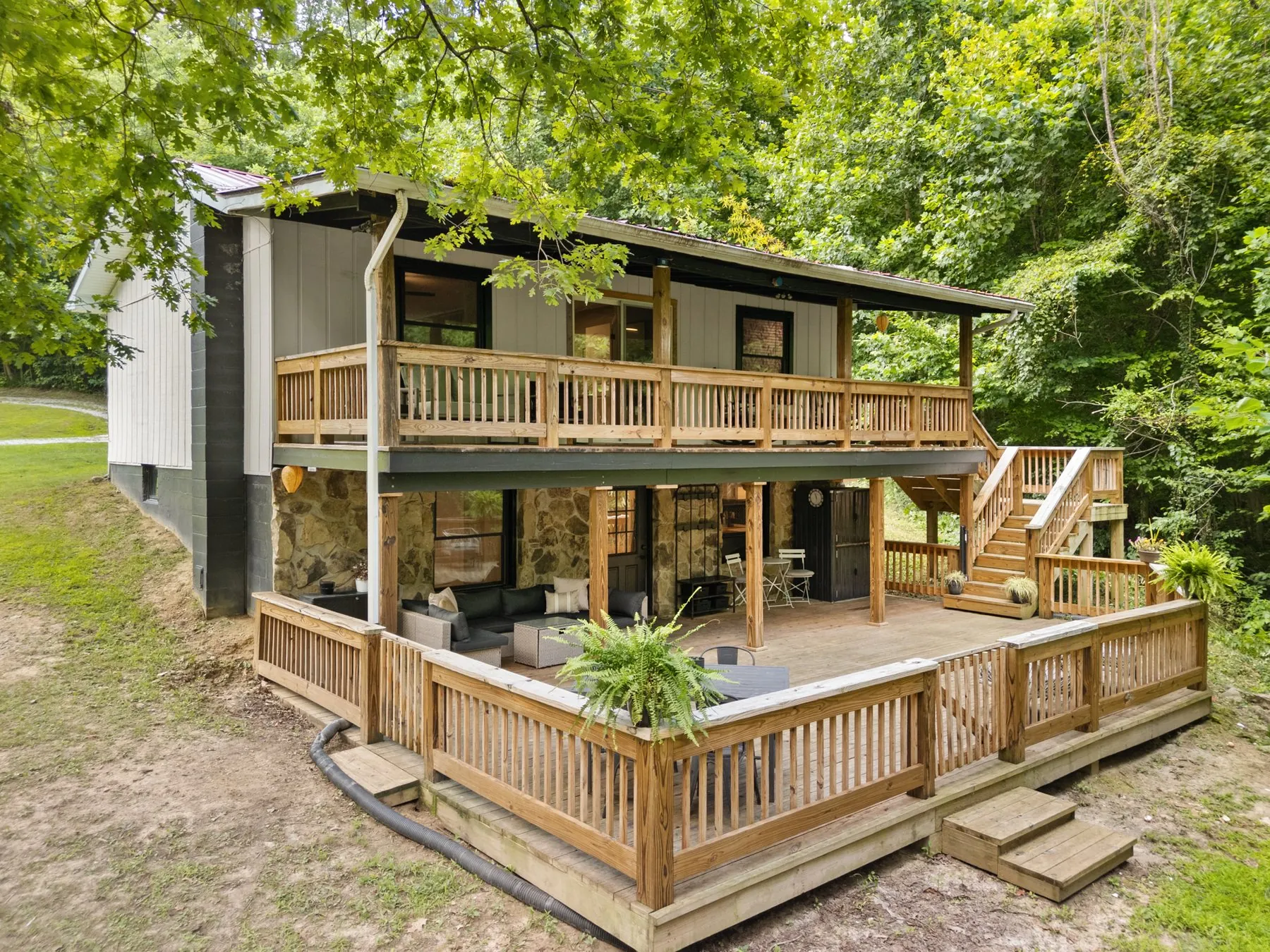 The lake side — stacked decks over the stone walk-out level