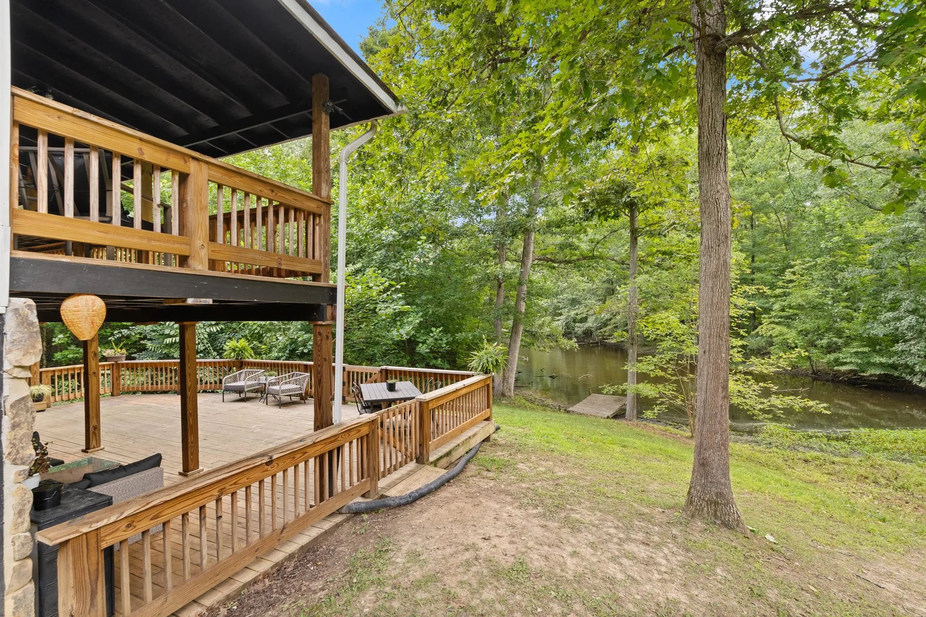 Lake side of the house: two levels of wood decking over a stone-faced walk-out level