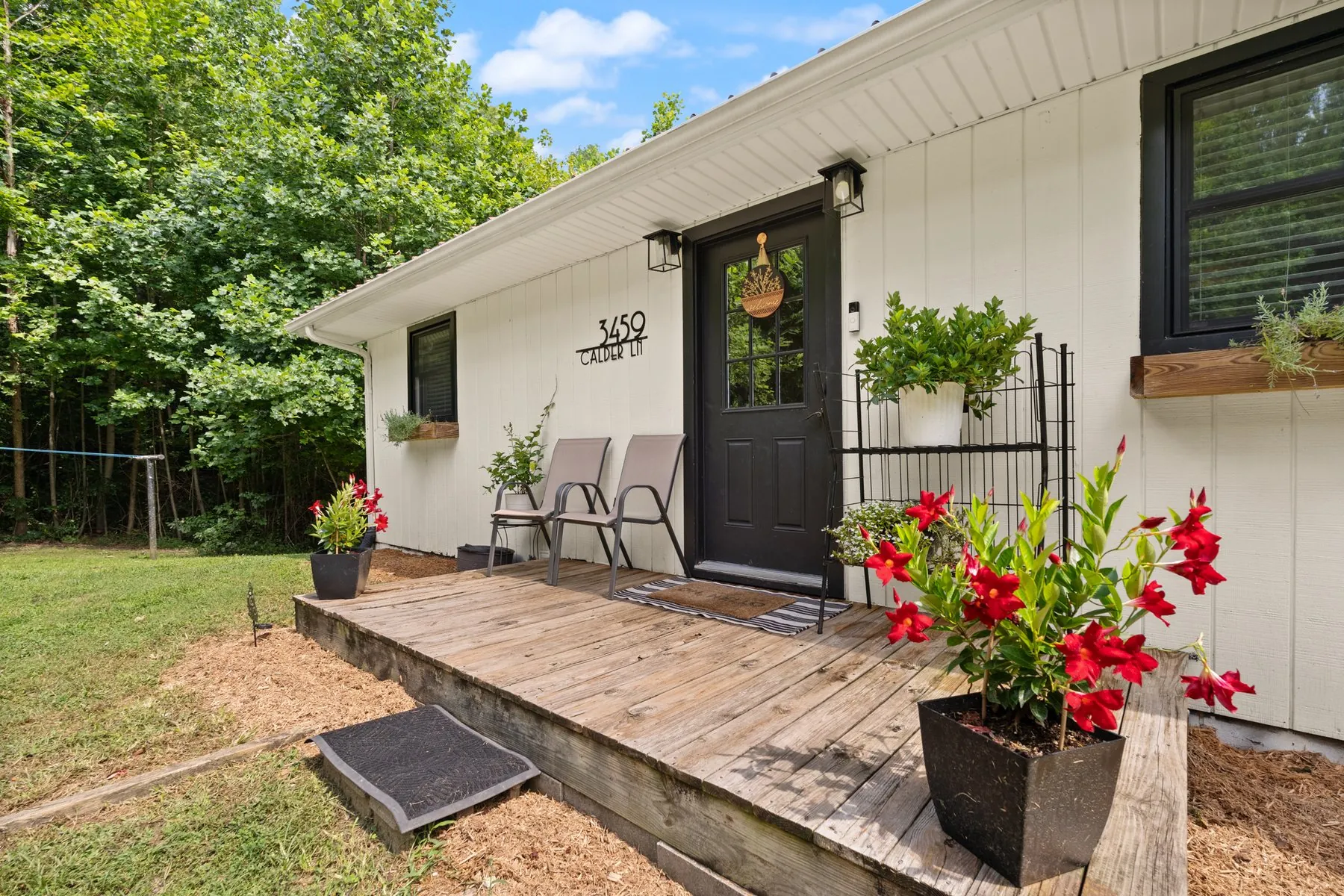Front porch — cedar window boxes and the house numerals