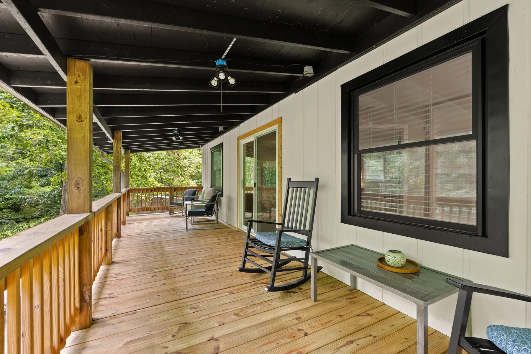 The 32-foot balcony — rocking chairs and black rafters