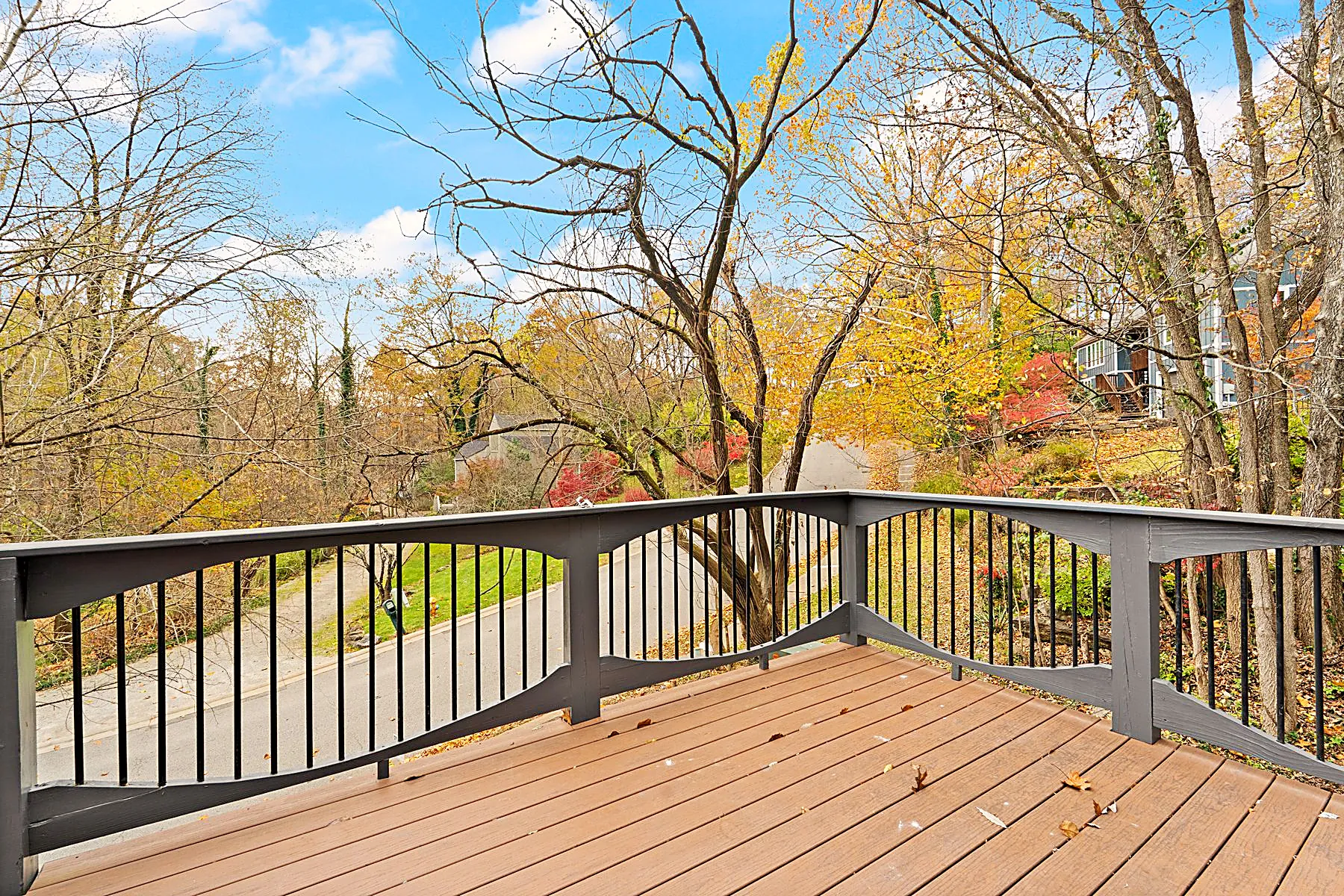 Rear deck overlooking a canopy of mature trees on the wooded lot