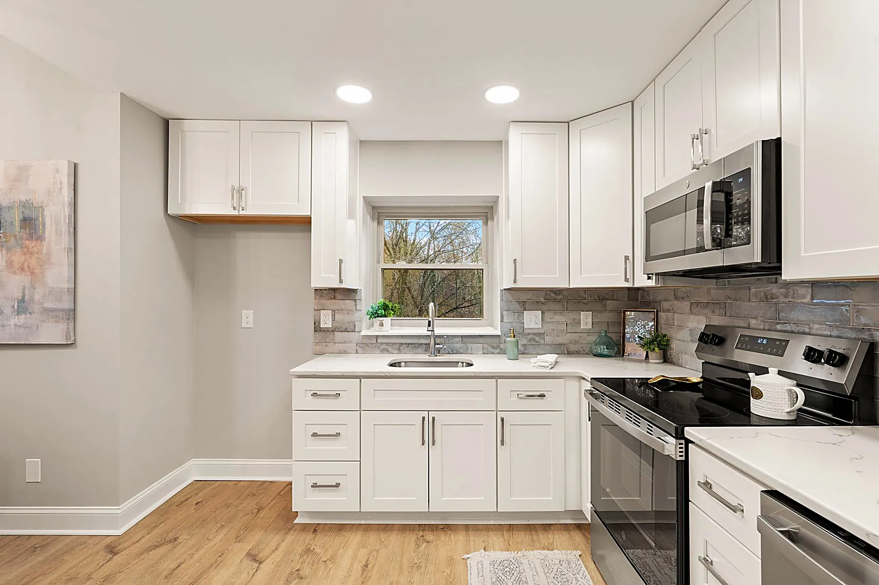 Updated kitchen with granite counters and stainless steel appliances