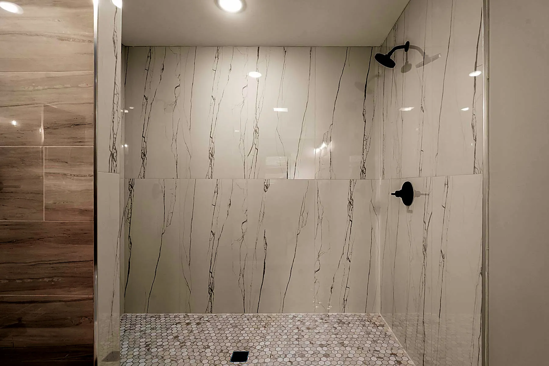 Primary bath with a fully tiled shower and dual shower heads