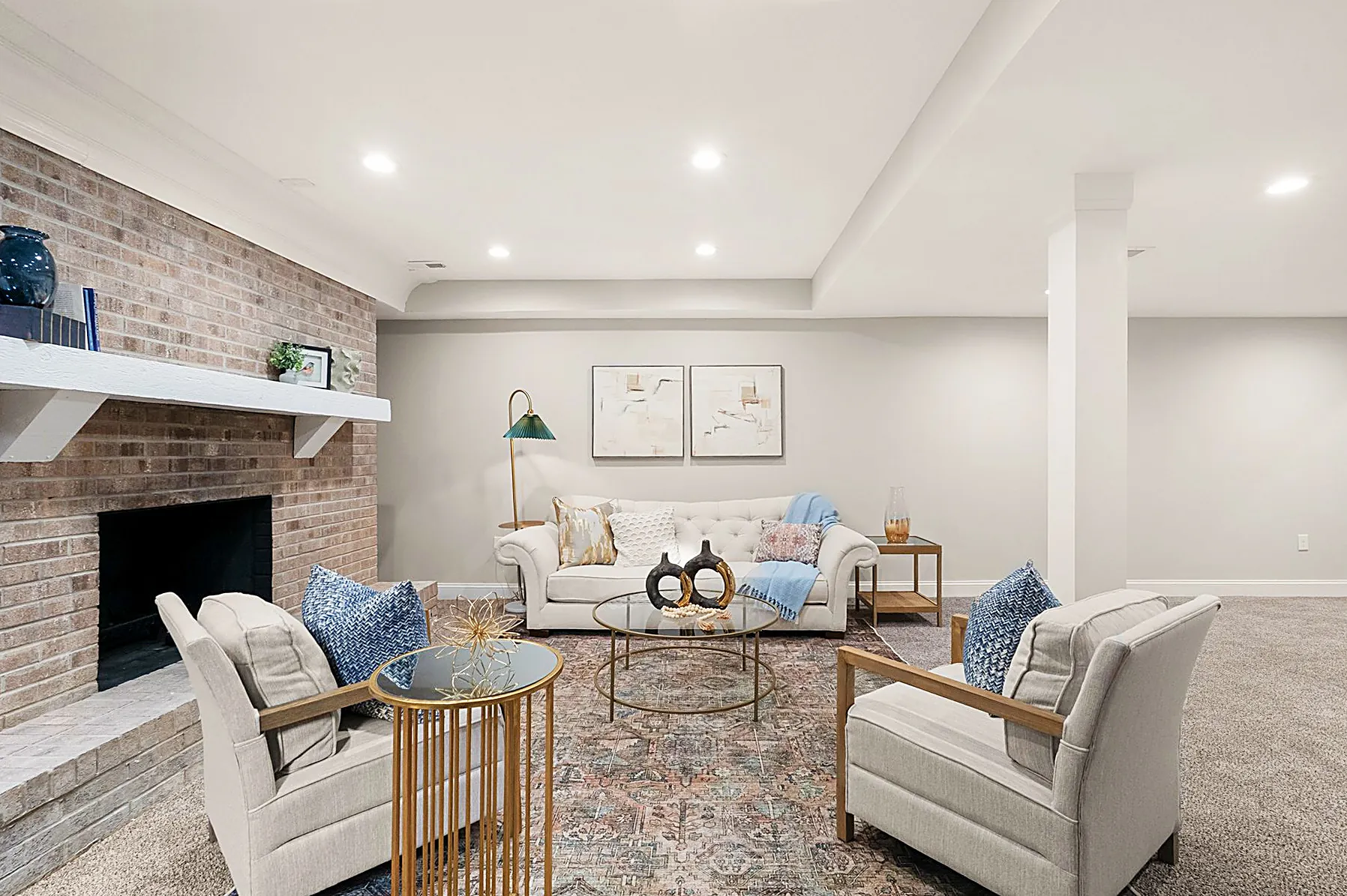 Walkout lower-level family room with a brick fireplace