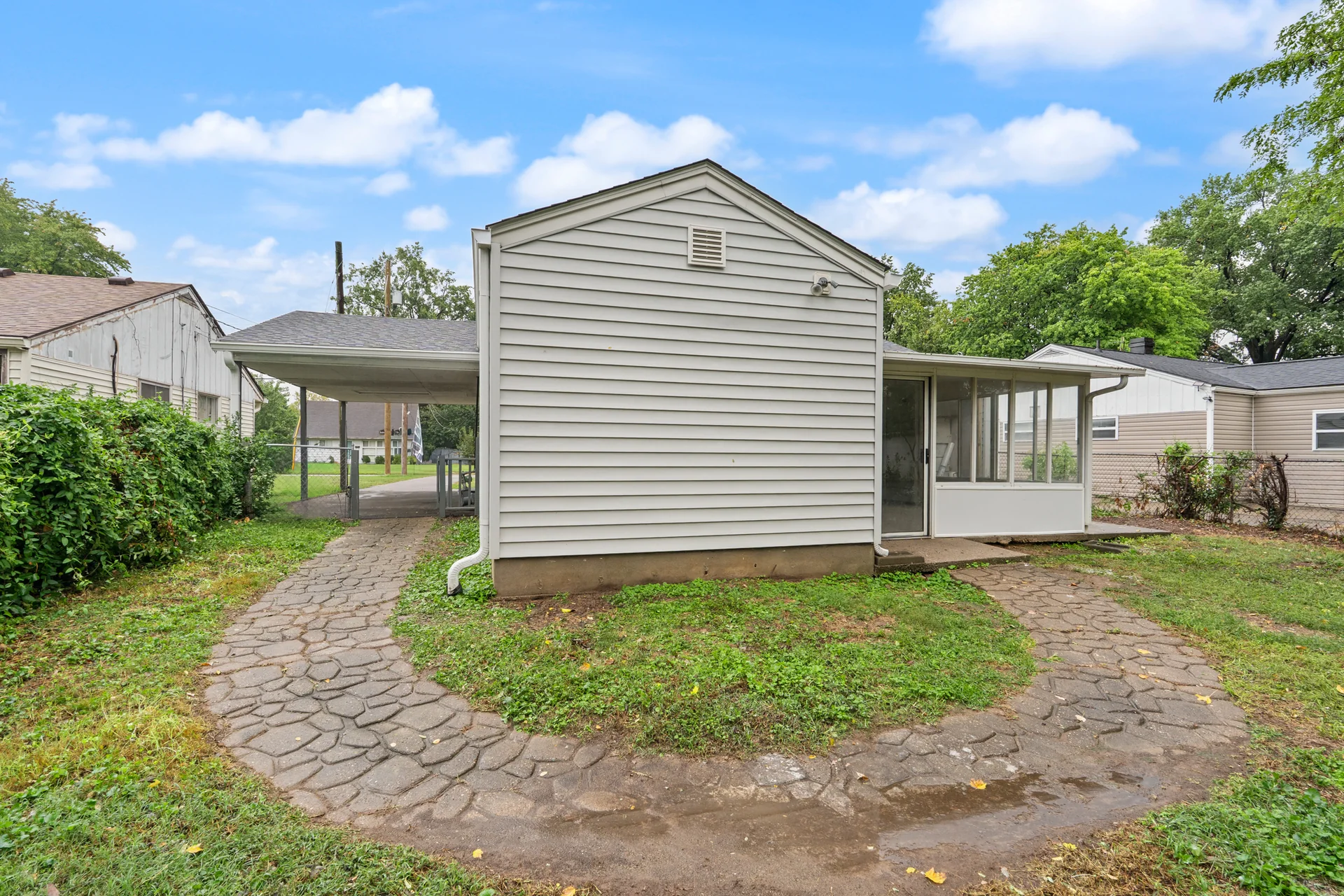 Side exterior and paved path at 4800 Partridge Run