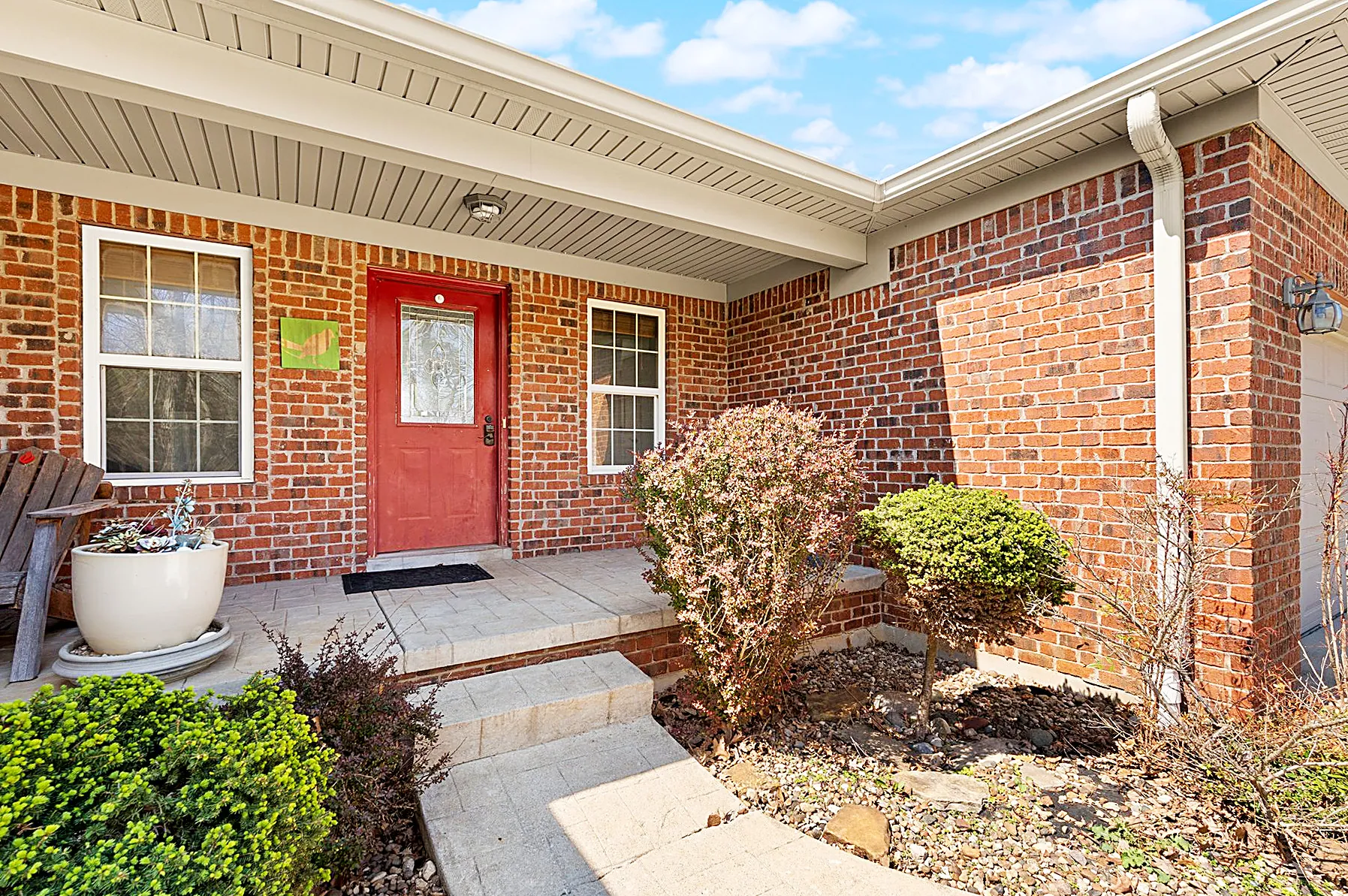 Covered front entry porch of the brick ranch