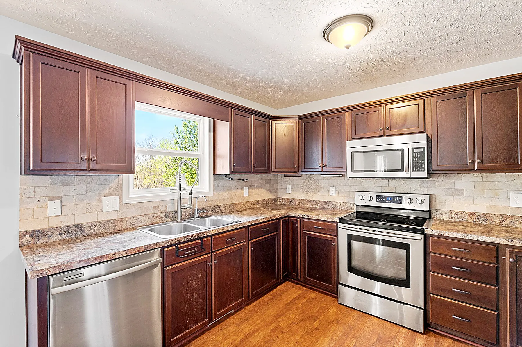 Kitchen with stainless steel appliances and granite counters