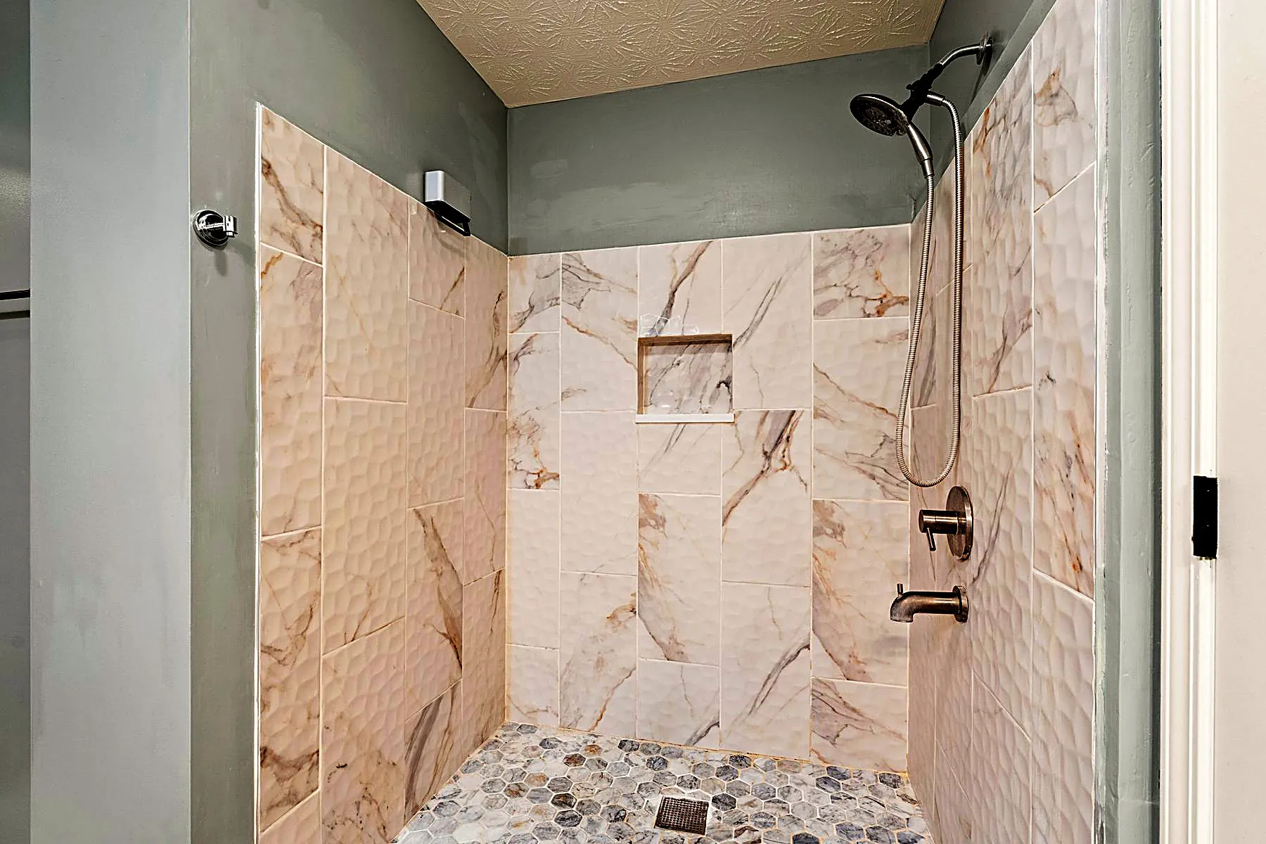Tiled walk-in shower in the primary en-suite bath