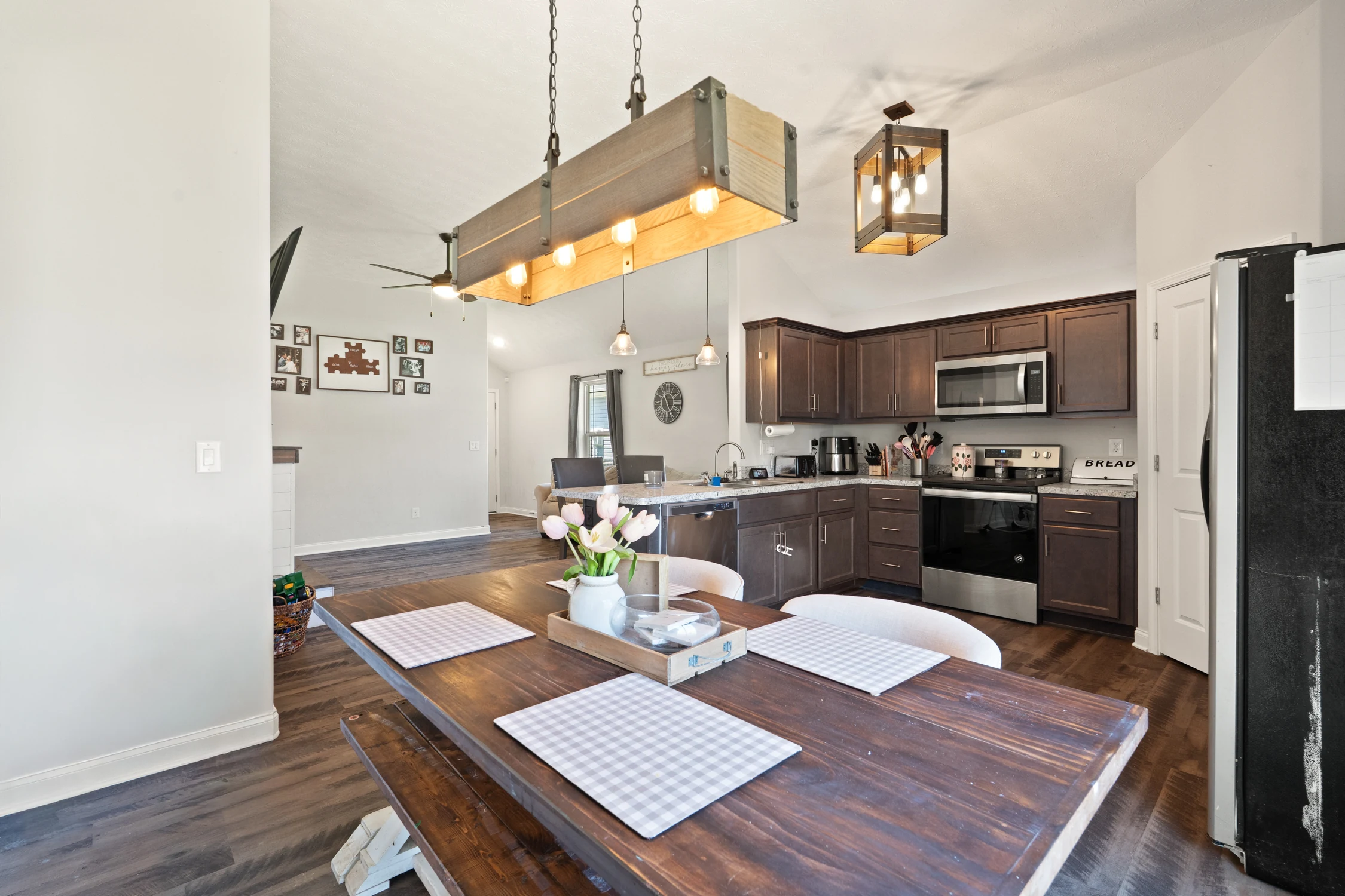 Eat-in kitchen and dining area with breakfast bar and warm statement lighting