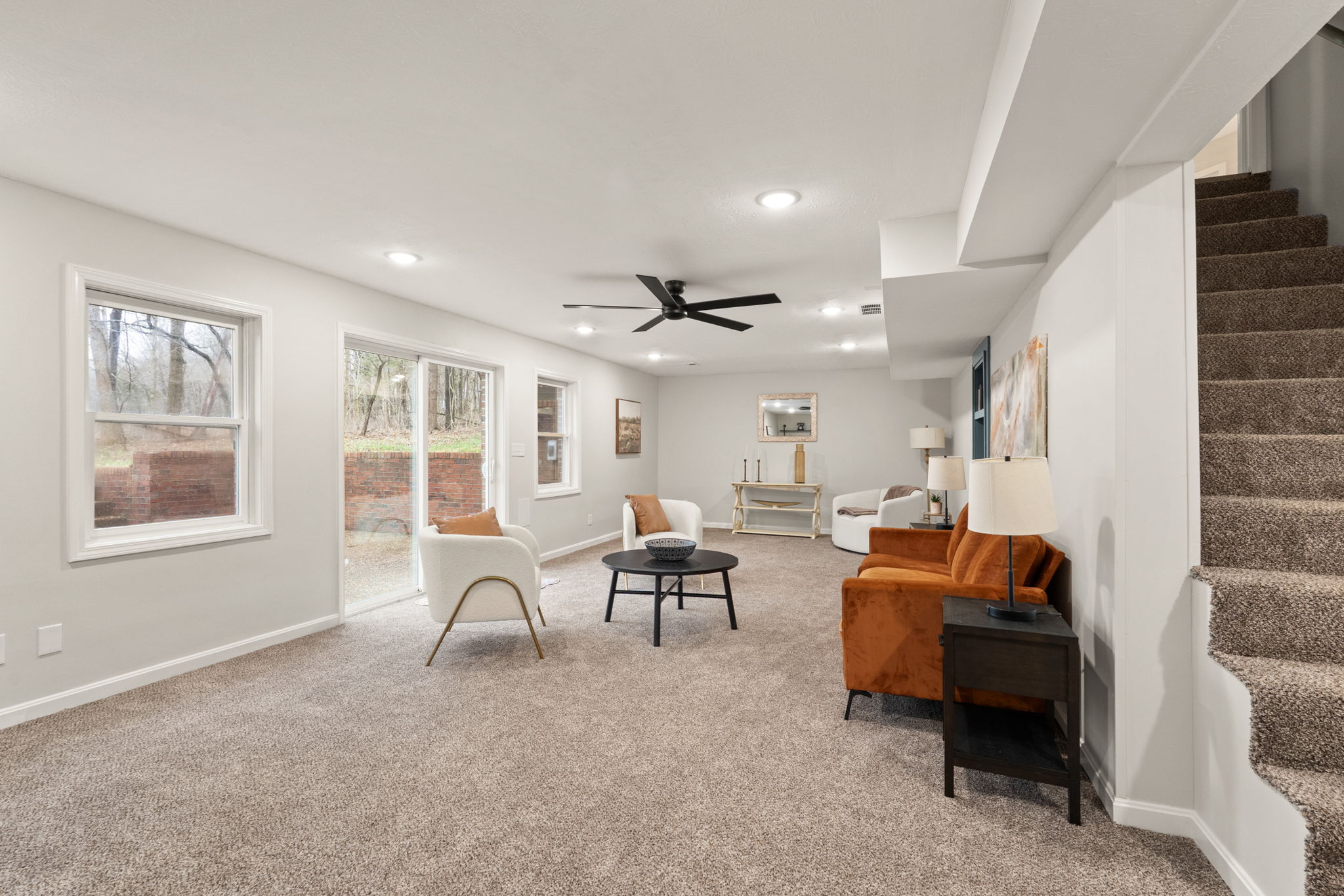 Basement family room with walkout windows, ceiling fan