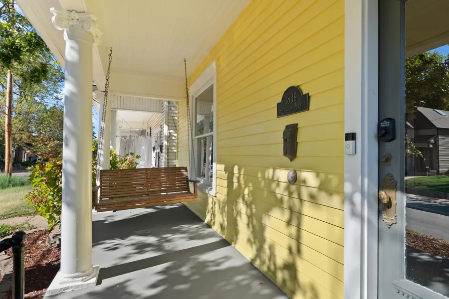 Covered porch with a swing and views of the street. 1839 Sherwood Avenue, Louisville, Kentucky.